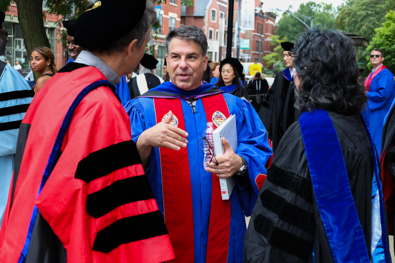 The President of DePaul University, Robert Manuel talks with other faculty outside of St. Vincent DePaul Parish on September, 3, 2025. Manuel awarded many faculty members throughout the ceremony.
