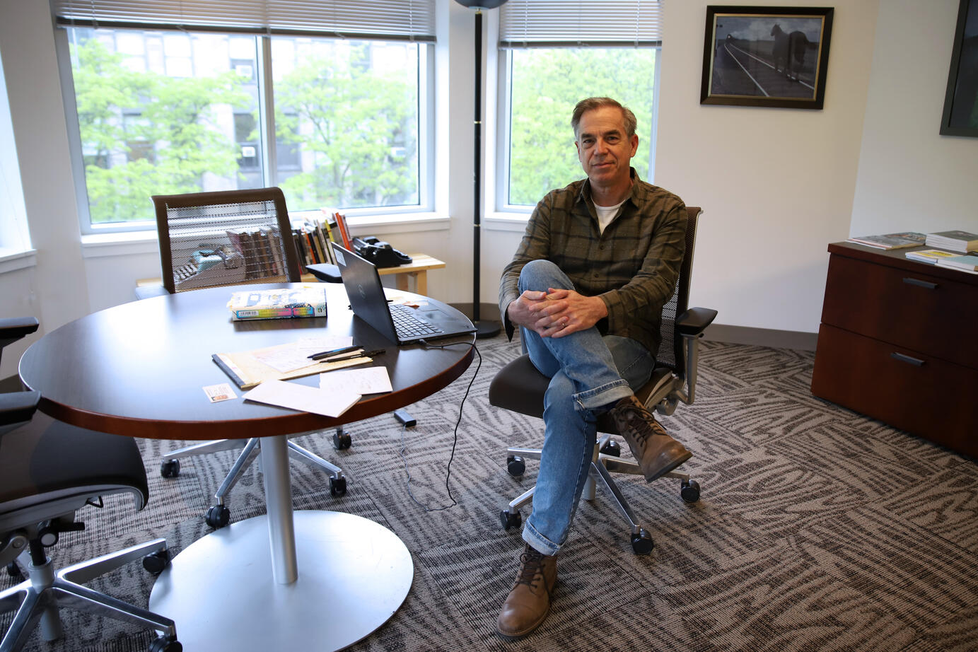 Professor Miles Harvey sits at his desk for a photo on Tuesday, May 20, 2025 in the Arts and Letters Hall. Harvey recently won the Midland Authors Award for fiction for his book “The Registry of Forgotten Objects.”