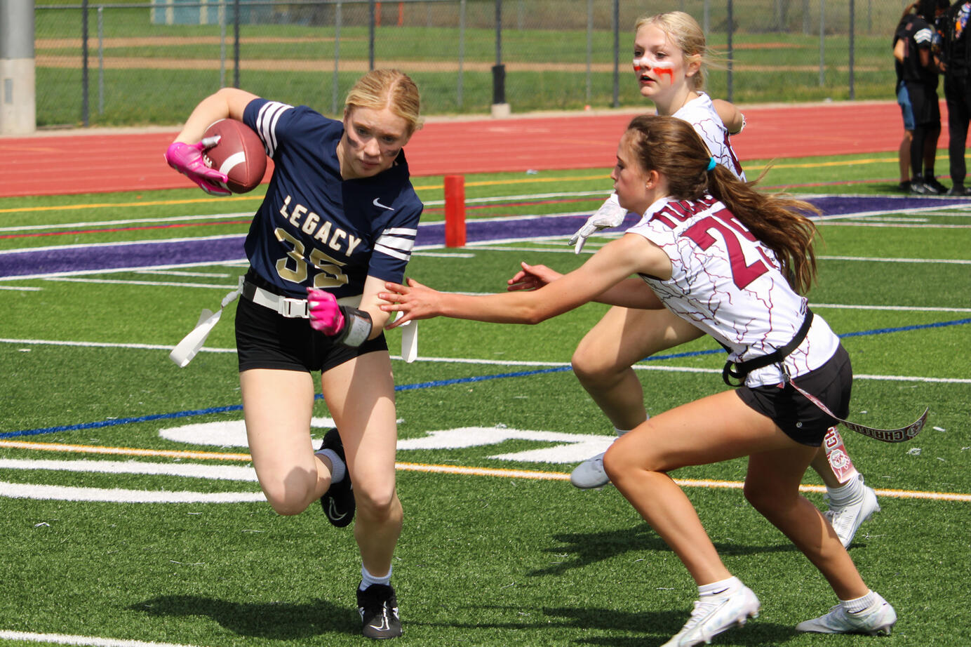 Kayle Bishop from Legacy High School runs with the football from the defense at Eaglecrest High School on September, 9, 2023. Flag football was a new sport to Legacy in the 2023-2024 school year.