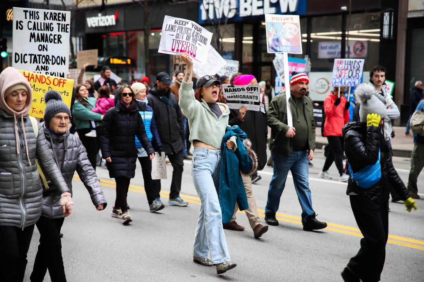 Barbara Galas marches down the streets of Chicago, holding up a sign during the nation-wide "Hands Off" protests on April 5, 2025. Thousands of Chicagoans were in attendance to the protest.